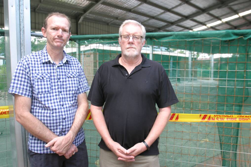 DISPLACED: Pastor Scott Tisdell and Lead Pastor John Crawford outside the burnt remnants of the school hall, which has been demolished. Picture: Jamieson Murphy