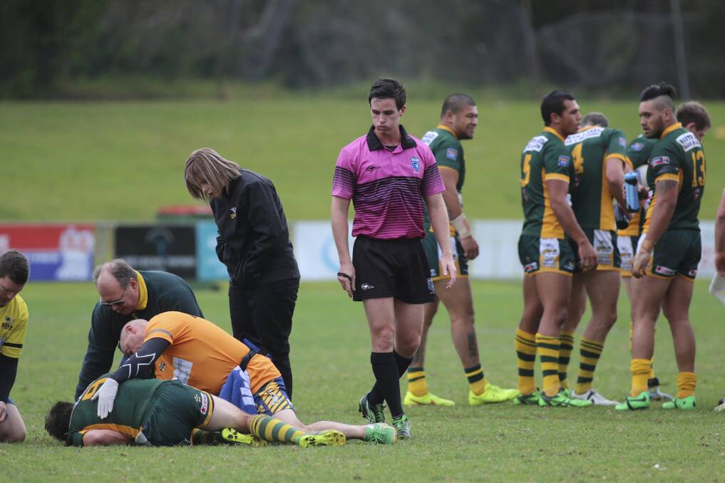 CONCERN: Wyong’s medical staff attend to Mitch Williams after the incident. Pictures: David Stewart
