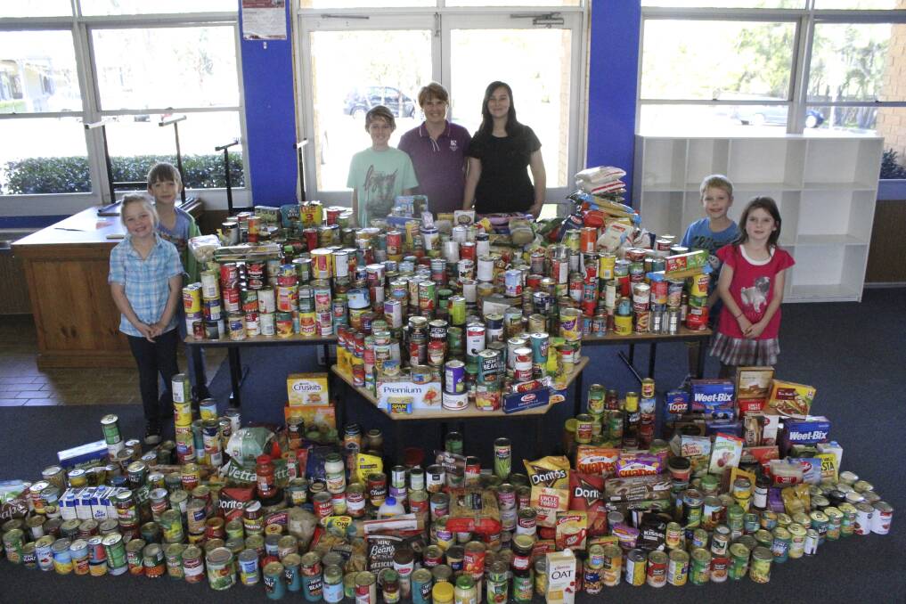GENEROUS: Avondale School Primary principal Debra Cooper with students Liam Borgas, Zoe Cochrane, Lucas Mesaric, Lily Schultz, Riley Hunt and Taya Nevell with the donated food.