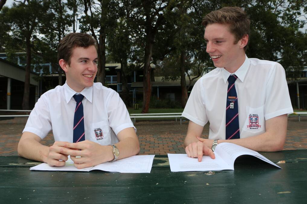 STUDIOUS: St Paul's Catholic High School students Lachlan Adams, left, and Bayley Amos compare notes after their HSC English exam at the Booragul school on Monday. Picture: Jamieson Murphy