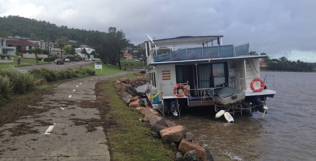 BEACHED: A house boat washed up on the foreshore of Lake Macquarie at Speers Point. Picture: Jamieson Murphy.