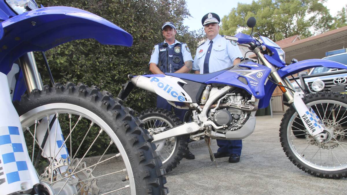 EFFECTIVE: Inspector Darryn Cox, right, with Senior Constable Andrew Johnson, and two of the Lake Macquarie Local Area Command's Yamaha bikes. Picture: David Stewart