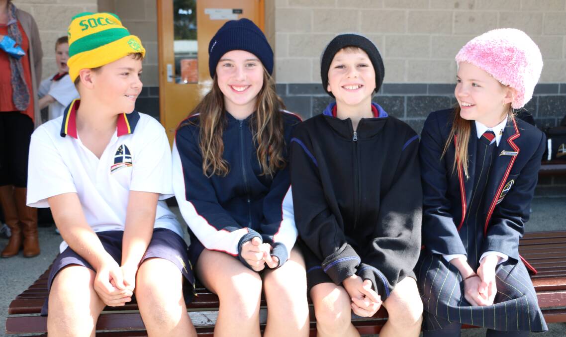 GOOD CAUSE: Students Callum Davies, Lily Everson, Isaac Dunn and Isabella Nowalinski compare headwear styles. Picture: David Stewart