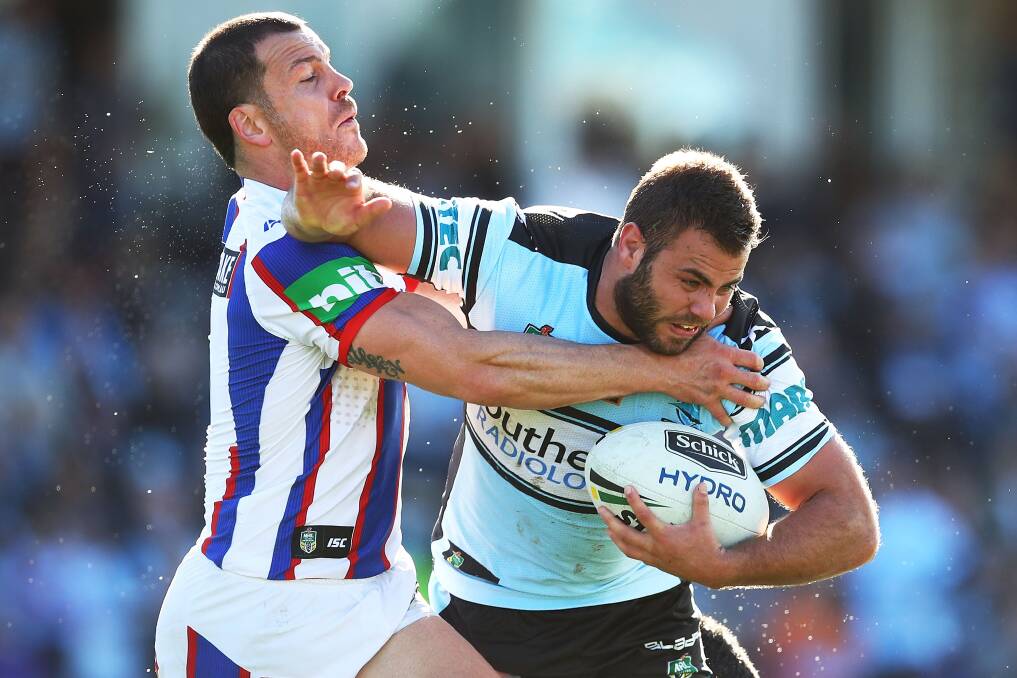 IN DOUBT: Jarrod Mullen makes a tackle on Wade Graham in the first-half against the Sharks.