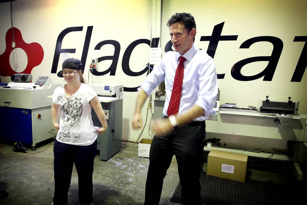 Greenacres employee Lucy Williams, 24,  and Throsby MP Stephen Jones in a dance-off at The Flagstaff Group in Unanderra on Thursday. Mr Jones was at the organisation with Cunningham MP Sharon Bird to reaffirm Opposition Leader Bill Shorten's support for Australian Disability Enterprises. Picture: Sylvia Liber