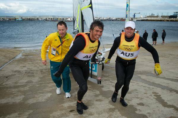 JOB DONE: Lake Macquarie sailors Iain Jensen (left) and Nathan Outteridge were all smiles after the penultimate Olympic 49er race at Weymouth, on Monday. Their final race was held yesterday. Picture: Jason South