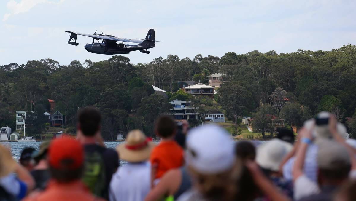 MAIN ATTRACTION: Festival-goers lined the shores of Lame Macquarie for the best vantage points to watch Felix the Black Cat come in low and slow. Picture: Peter Stoop