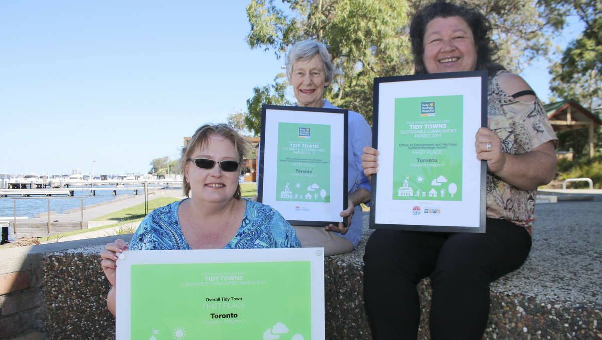 TRIFECTA: Pictured celebrating their win on the Toronto waterfront are, front, Kelly Hoare of the Toronto Tidy Towns Committee, with, back row from left, Robyn Gill of Coal Point Landcare, and Anita Barker of the Westlakes NAIDOC Committee. Picture: David Stewart