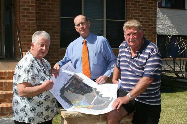 NIGHTMARE: Carol and John Hannaford consider plans for their newly built house with Cr Greg Best (centre). Picture: David Quick