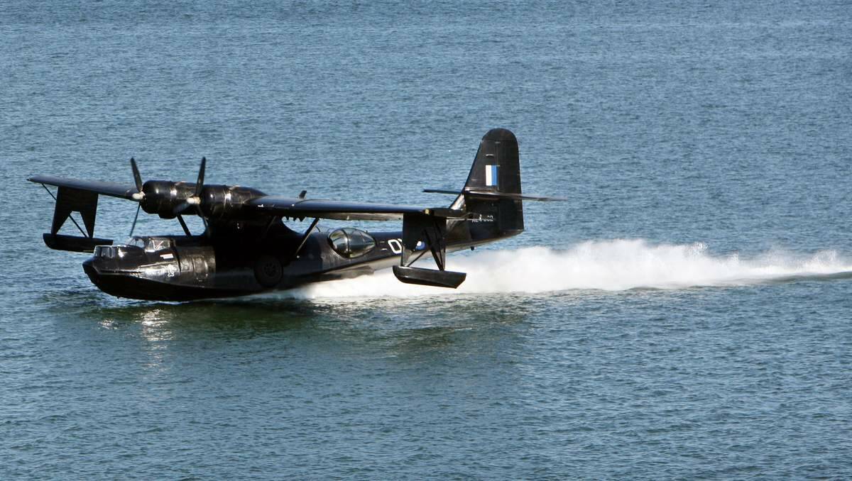 DRAWCARD: Felix the Black Cat’s landing on Lake Macquarie in 2012 attracted a record crowd to the annual Rathmines Catalina Festival. Rathmines will soon have its own Catalina on permanent display. Picture: Sylvia Liber