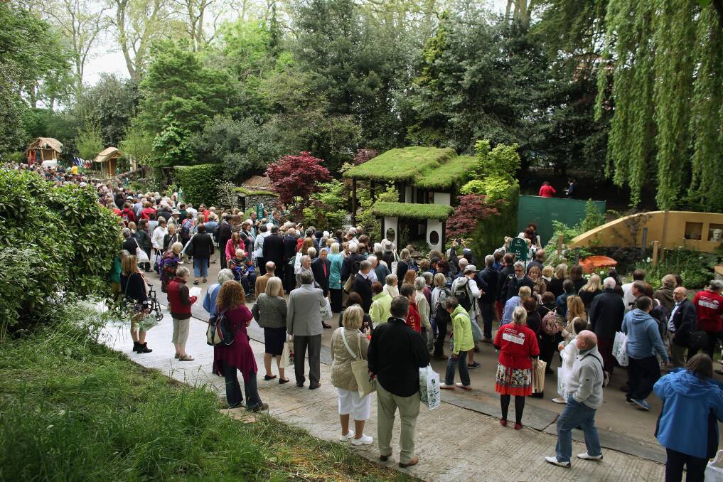 Visitors admire the gardens along Serpentine Walk of the RHS Chelsea Flower Show on May 21, 2013 in London, England. Photo by Oli Scarff/Getty Images