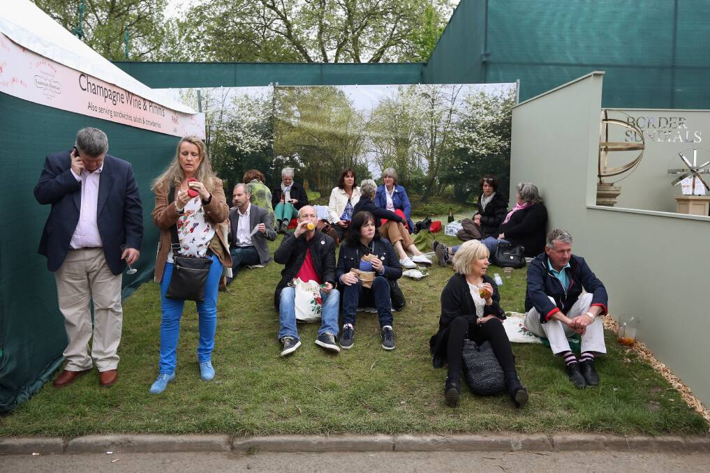 Visitors relax next to a champagne bar at the RHS Chelsea Flower Show on May 21, 2013 in London, England. Photo by Oli Scarff/Getty Images