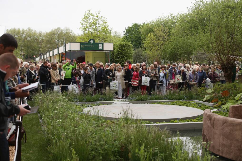 Visitors admire the B&Q Sentebale Forget-Me-Not Garden, inspired by Prince Harry, at the RHS Chelsea Flower Show on May 21, 2013 in London, England. Photo by Oli Scarff/Getty Images