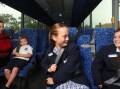 Regional Transport and Roads minister Jenny Aitchison with East Maitland Public School students Sebastien Atkins, 5, Milly Watts, 12, and Bowie Myers, 11, on a bus with new seatbelts. Picture by Simone De Peak 