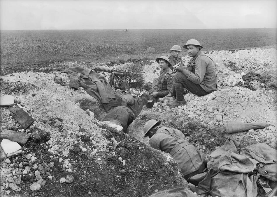 RESPITE: Meal time at 5th Australian Machine Gun Battalion on Hill 104 at Villers-Bretonneux. The position was critical for the defence of Allied rail routes to the west at Amiens. Picture: AWM E02296