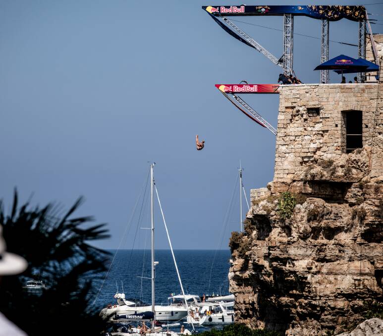HIGH FLYER: Lake Macquarie's Rhiannan Iffland takes the drop on her way to winning the Red Bull cliff-diving competition at Polignano a Mare, Italy. Her victory ensured she finished the season as world champion. Pictures: Romina Amato/Red Bull Content Pool