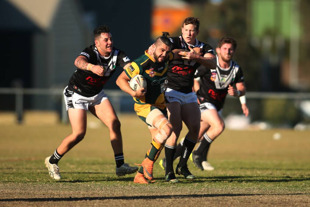 ON THE CHARGE: Macquarie's Randall Briggs brushes off the defence. 
