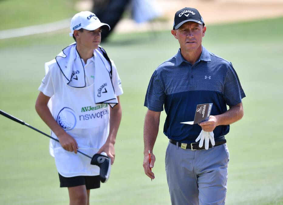 LEARNING CURVE: Jake Riley (left) on the job as a caddy for former US tour player Nathan Green at the NSW Open. Picture: AAP