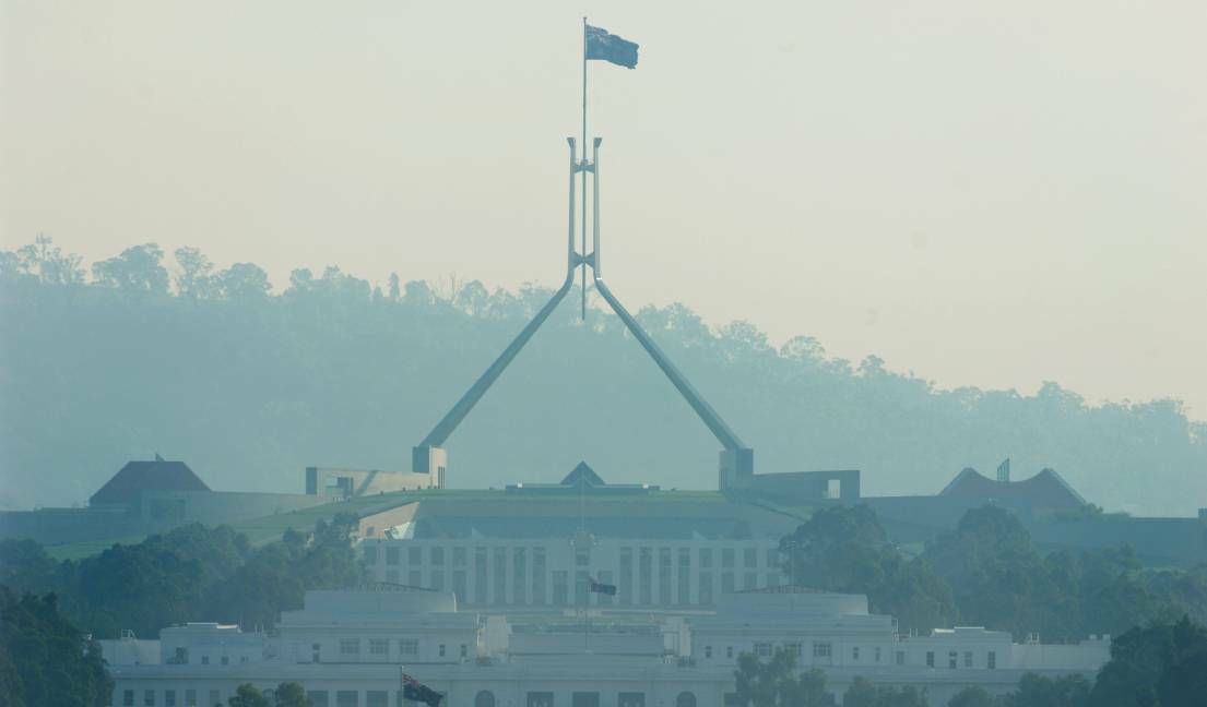 No filter: Smoke from a bushfire settles over Parliament House. Picture: Marina Neil 