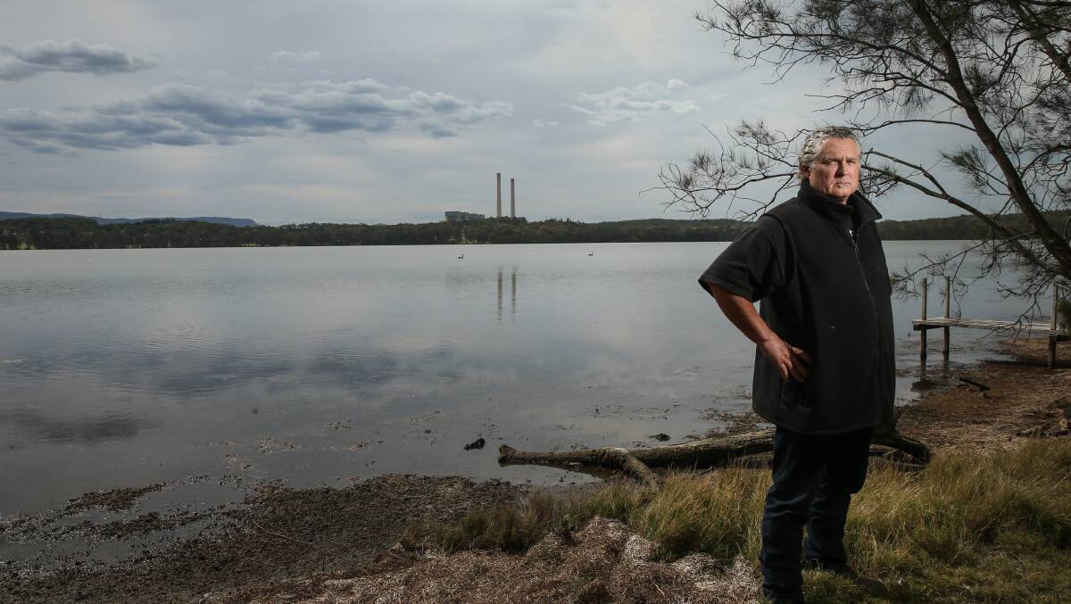 CONCERNED: Hunter Community Environment Centre's Paul Winn at Dora Creek, with Eraring power station in the background. The Origin Energy-owned station is seeking to expand its ash dam. Picture: Marina Neil