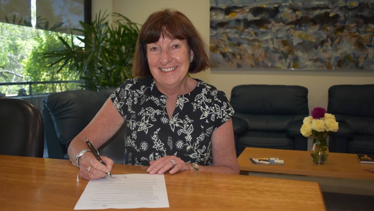 INCLUSION:  Mayor of Lake Macquarie, Cr Kay Fraser, signs the Welcoming Cities commitment.