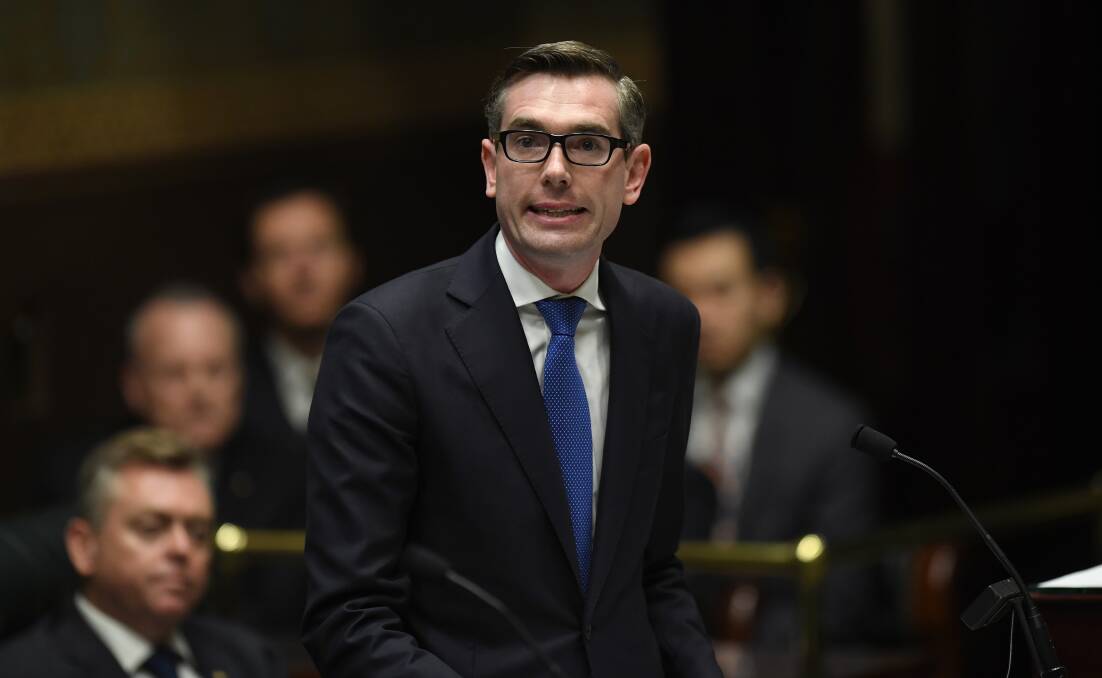 NSW treasurer Dominic Perrottet hands down the budget in parliament on Tuesday.