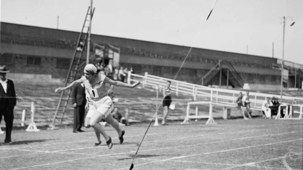 Chrissie Dahm crossing the finishing line in a running race in NSW circa 1930. Image: National Library of Australia; Fairfax Archive
