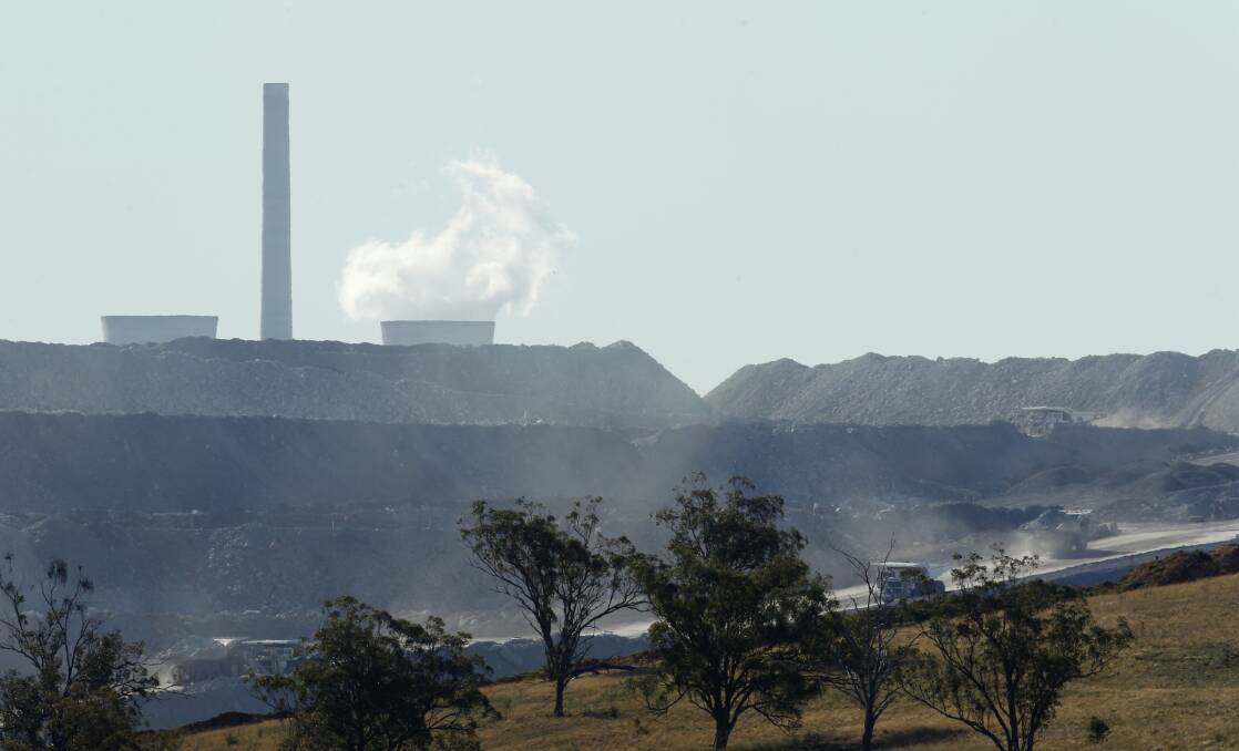Choked up: Dump trucks working with Bayswater Power Station in the background. Picture: Max Mason-Hubers