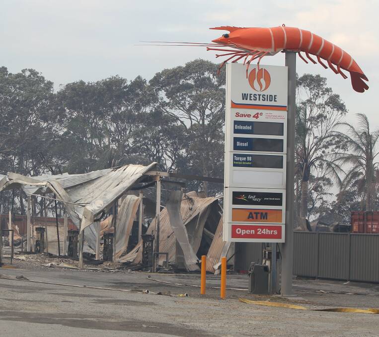 Scorched: The big prawn survived but the service station was destroyed in the Catherine Hill Bay fire.
