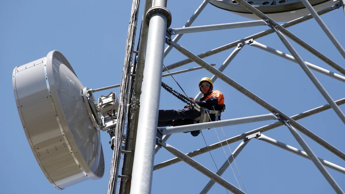 A worker on a telecommuications tower in Sydney. Picture: Damian White
