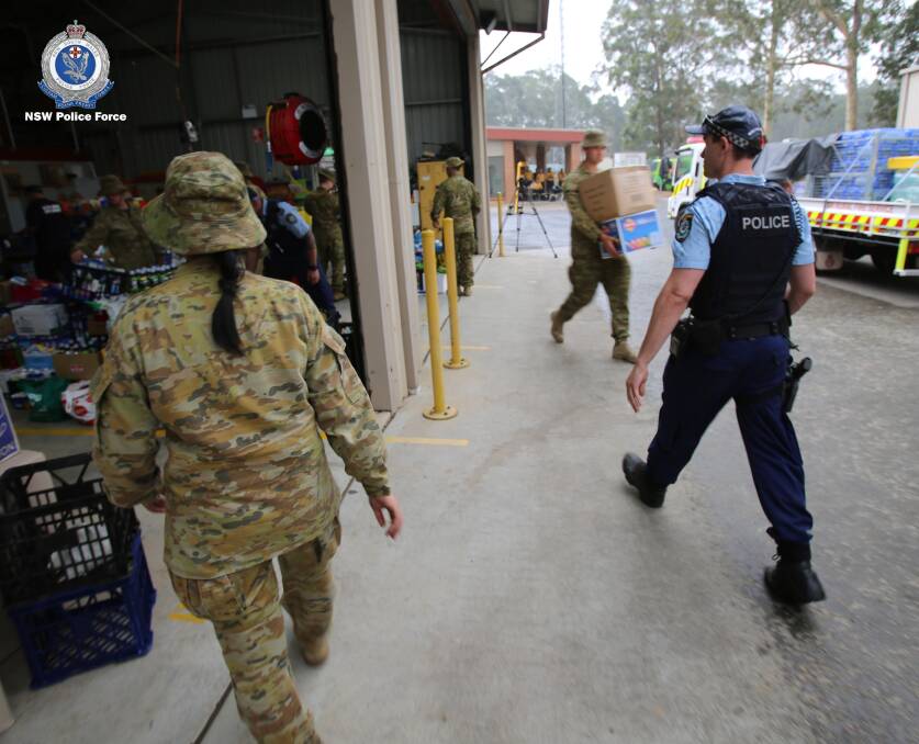 MAJOR OPERATION: Police and Australian Defence Force personnel loading supplies onto trucks as part of the bushfire relief effort on the South Coast. Picture: NSW Police Media