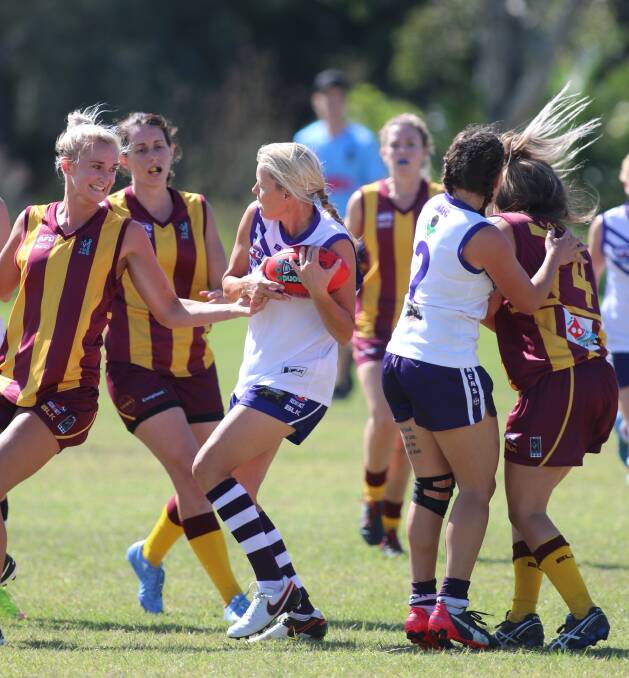 GOOD SPIRITS: Lake Macquarie Dockers win this scramble for possession in the women's Black Diamond Cup match at Teralba on Saturday. Picture: David Stewart