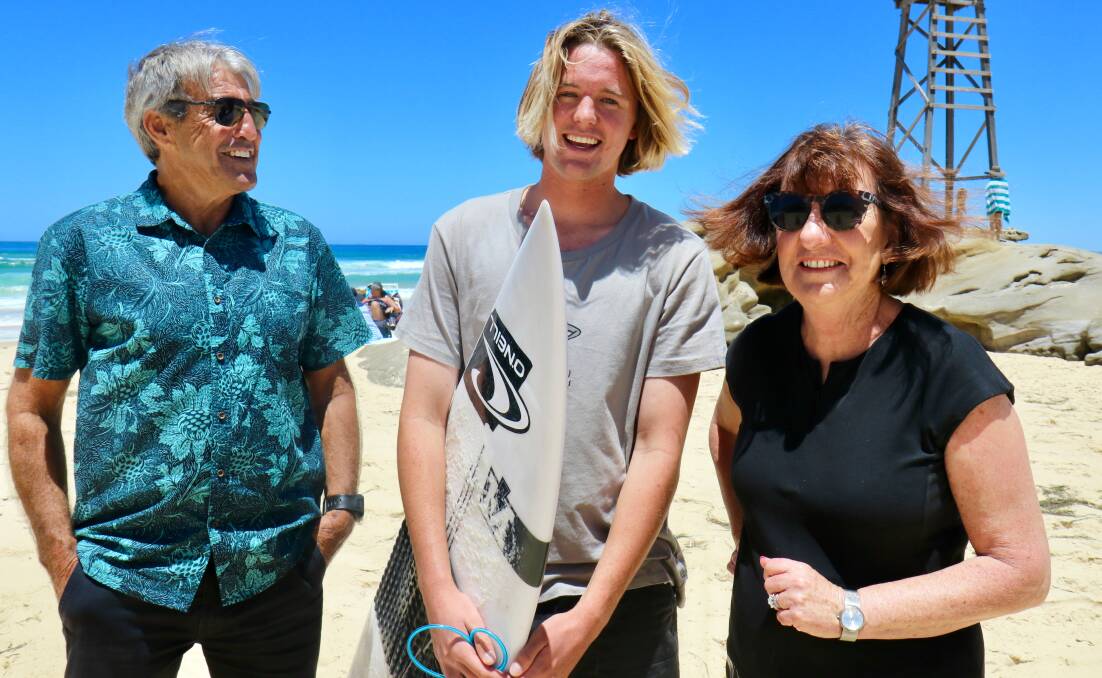 ANTICIPATION: Surfest organiser Warren Smith, left, with junior surfer Connor Lee and mayor Kay Fraser at Redhead Beach which will host the Lake Mac City Pro Junior in February. Picture: Supplied 