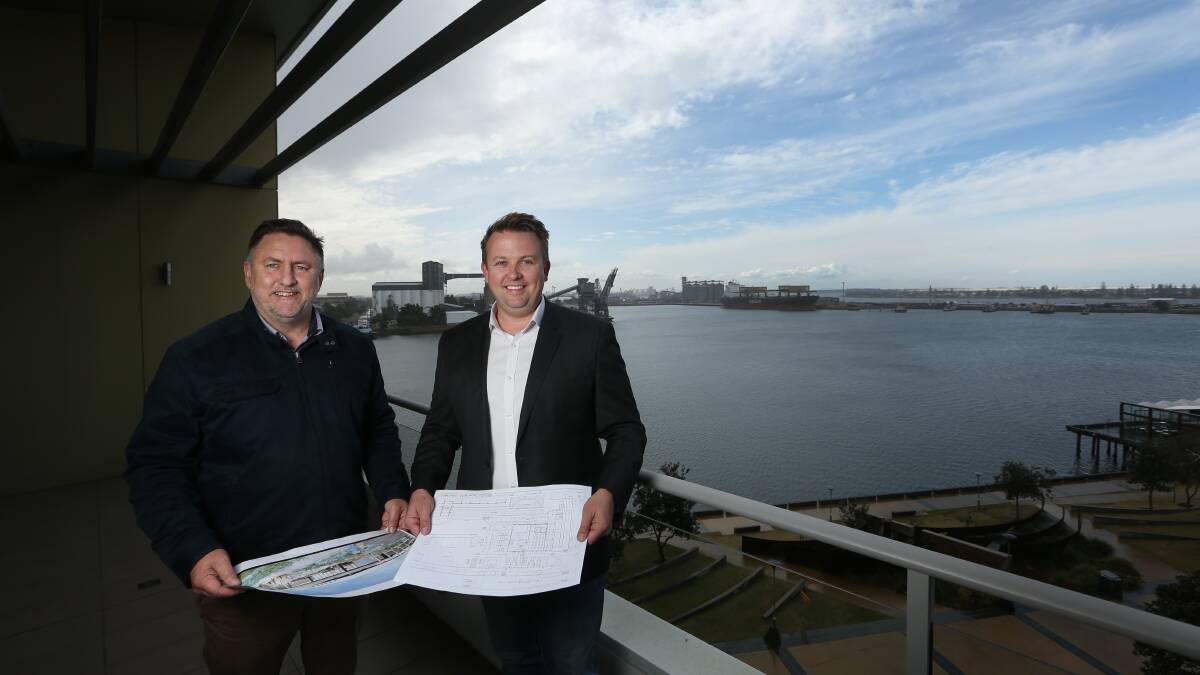 BIG PICTURE: Cedar Mill general manager Kyle McKendry, left, and Winarch Capital managing director Paul Lambess look over plans for the Morisset proposal. Picture: Marina Neil