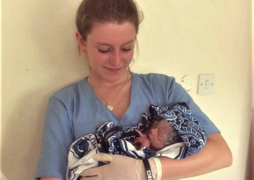 INITIATIVE: Young Morisset Rotary Club member Eleni Comino, pictured with a newborn during her assignment at Morogoro Maternity Hospital, in Tanzania. Picture: Supplied