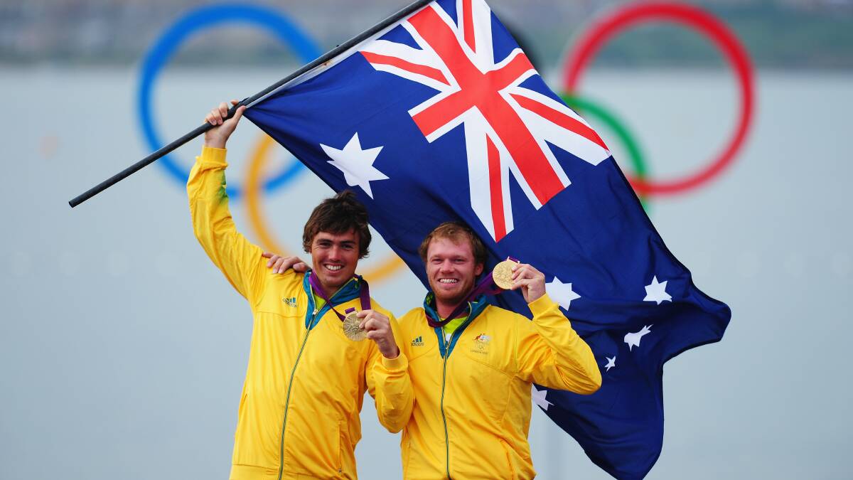 LOCAL BOYS: Iain Jensen, left, and Nathan Outteridge celebrate their gold medal at the London Olympic Games of 2012. Picture: Laurence Griffiths