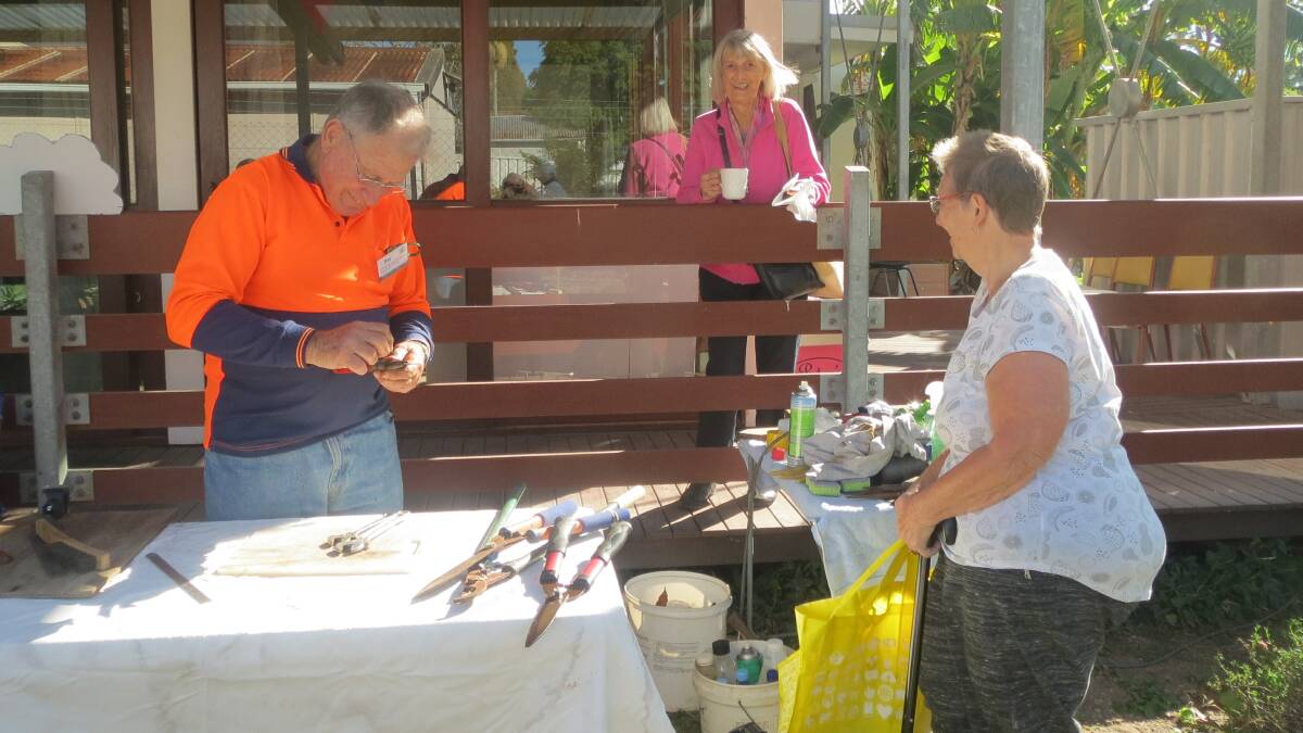 SHARP OPERATOR: Experienced handymen showed how to put the edge back on ageing garden tools at the Toronto repair cafe. Picture: Supplied