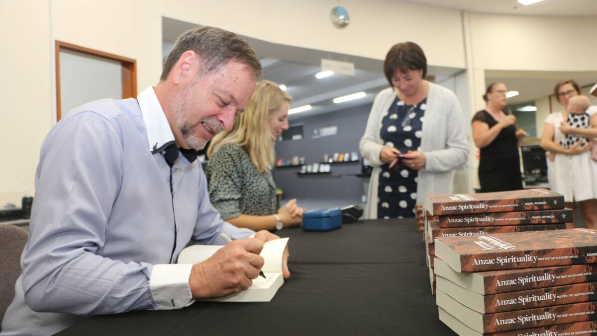 COORANBONG: Associate Professor Daniel Reynaud signs copies of his new book at its launch at Avondale College of Higher Education. Picture: David Stewart.