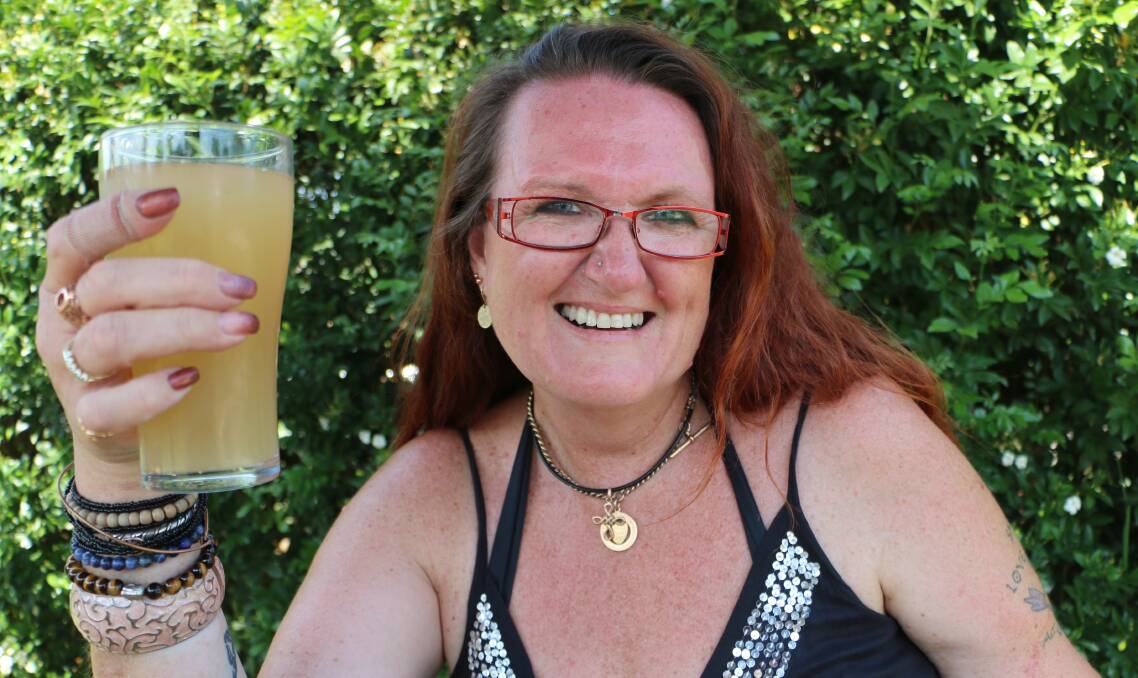 HERE'S CHEERS: Jacqui Brown with a sample of her ginger beer. She's been convinced by friends and family to enter her creation in the home brewing section of the Morisset Show this weekend. Picture: David Stewart