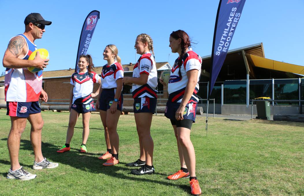 LEAGUE NURSERY: Club president and under-16s girls coach, Troy Agar, with some of the Roosters' female players. Picture: David Stewart