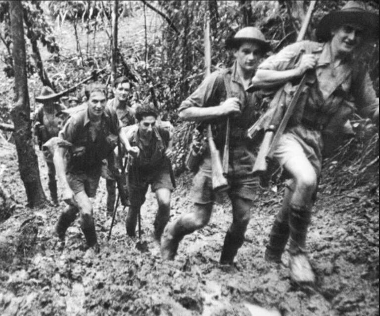 OUR HISTORY: Australia soldiers trudging through mud on the Kokoda Track, in Papua New Guinea, during World War II. Picture: Australian War Memorial.