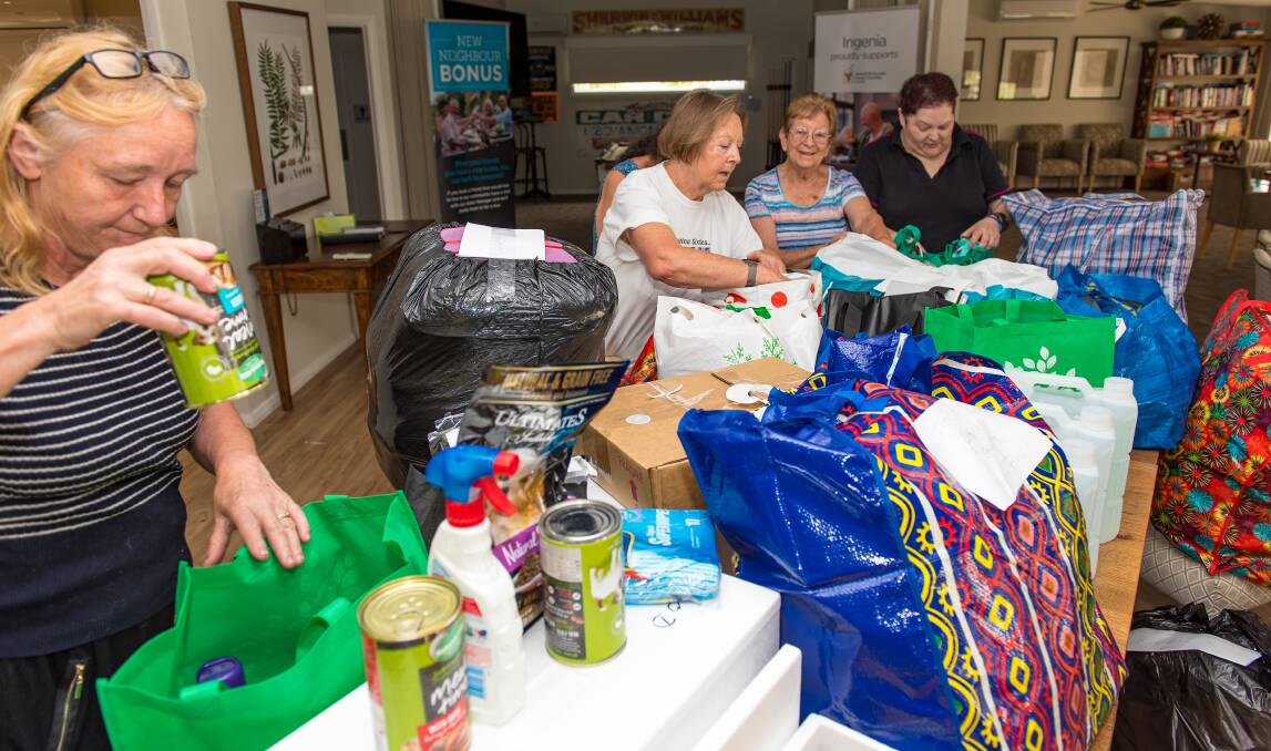 GOOD TO GO: Locals pack the assortment of donated foodstuffs, clothing, toiletries and pet and animal supplies for the trip to Taree. Picture: Chris VanderSchaaf