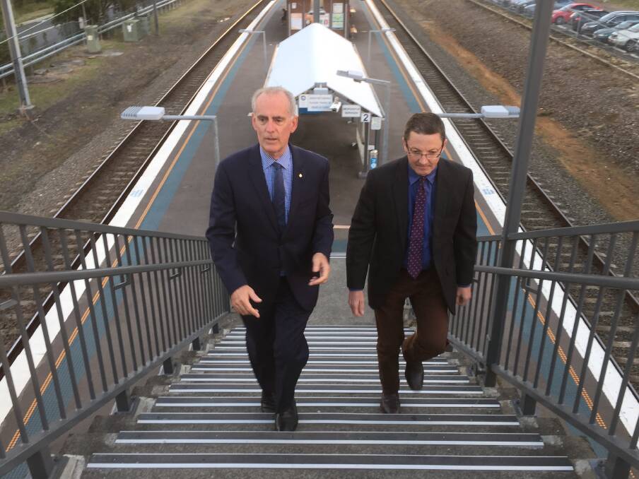 HIGHER CALLING: Lake Macquarie MP Greg Piper, left, with Parliamentary Secretary for the Hunter Scot MacDonald climbing the Wyee Station steps on Monday.