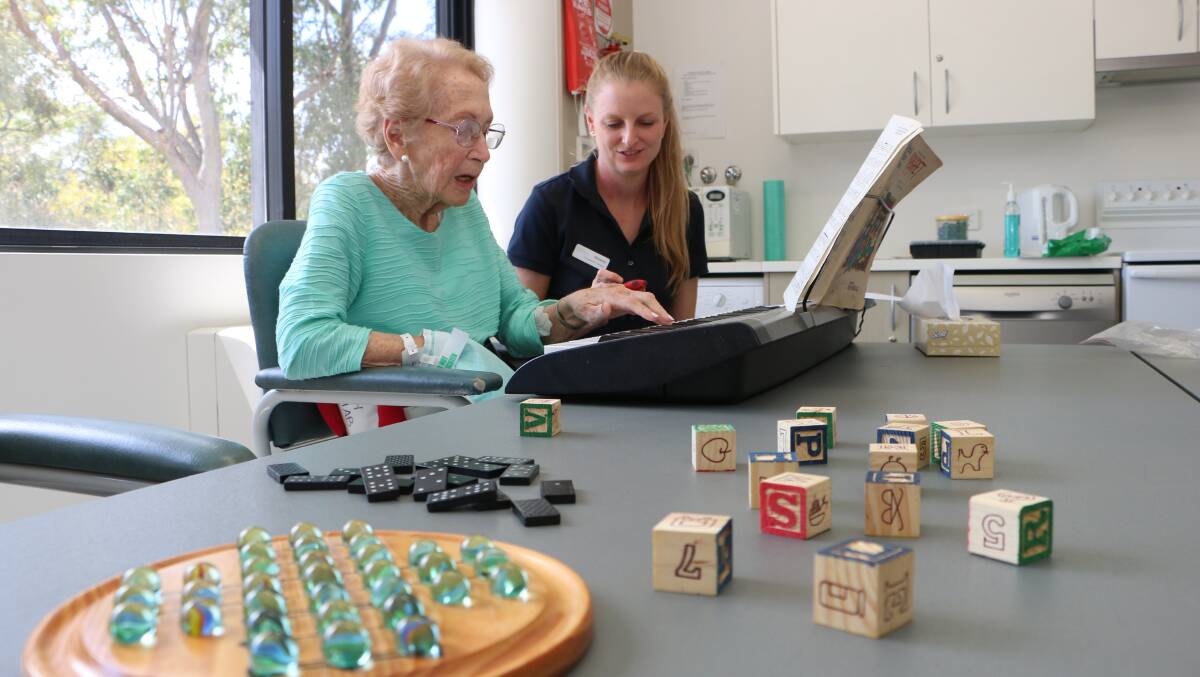 EXERCISES: Janice McCarty performs a musical scale drill on the keyboard under the watchful eye of occupational therapist Melanie Glapa. Picture: David Stewart