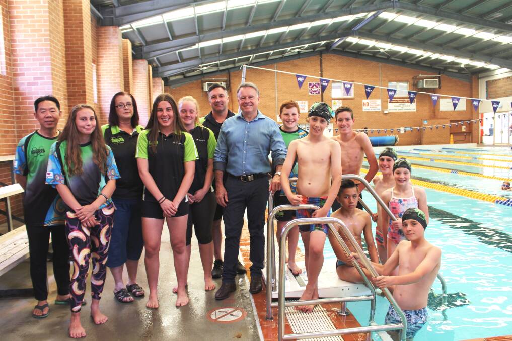 GOOD TIMING: Macquarie Shores Swimming Club received a $5,264 Stronger Communities grant in Round 3 of funding last year. The money was used to buy a digital scoreboard. Joel Fitzgibbon is pictured with club members at the Toronto Swim Centre. Picture: Supplied