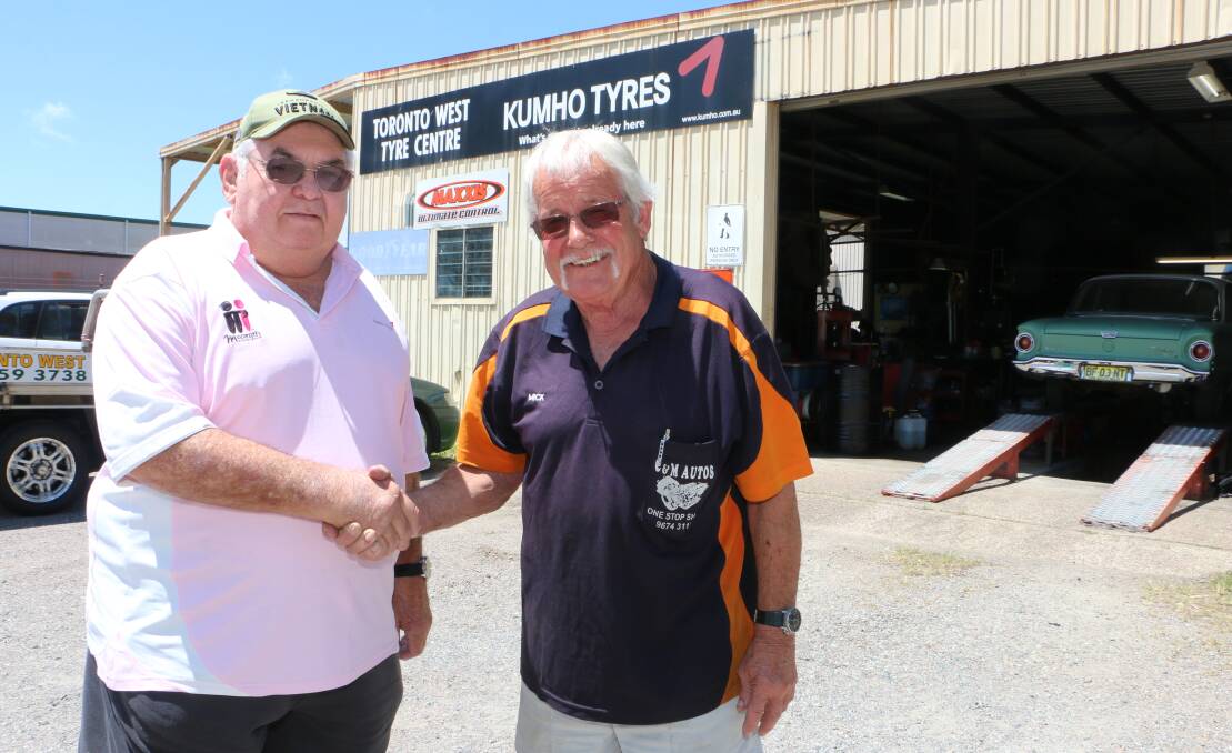 ALL YOURS: Neville Heaton, left, welcomes Mick Linnane as the new owner and operator of Toronto West Tyre Centre, on Nicholson Street. Picture: David Stewart