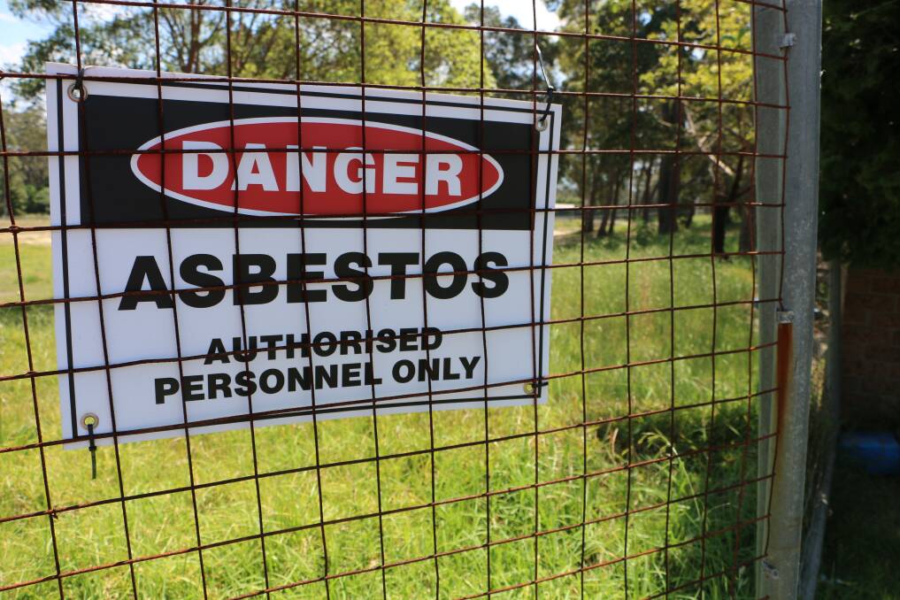 COSTLY DANGER: Fencing and signs exclude locals from accessing a part of Bernie Goodwin Memorial Park, in Morisset, where asbestos was found buried near a playground. Picture: David Stewart