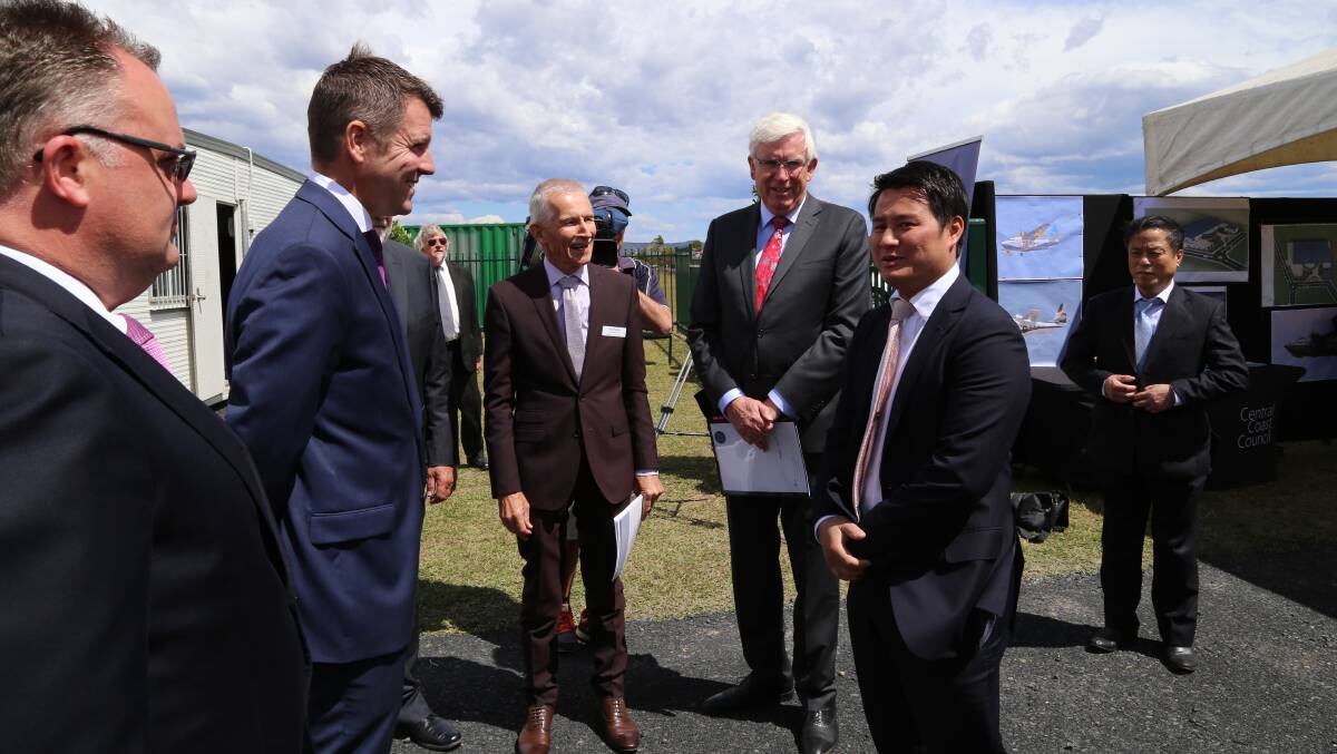 ANNOUNCEMENT: Premier Mike Baird, left, with Amphibian Aircraft Group president Khoa Hoang, at Warnervale today. Picture: Supplied