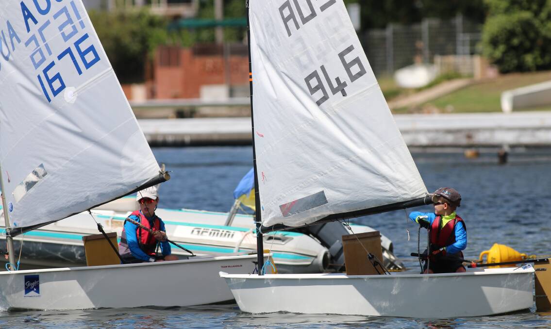FAST LEARNERS: Two young competitors head out onto Lake Macquarie to contest a heat in the recent Trinity Point NSW Optimist Championships. The event has sparked interest in learn-to-sail classes. Picture: David Stewart