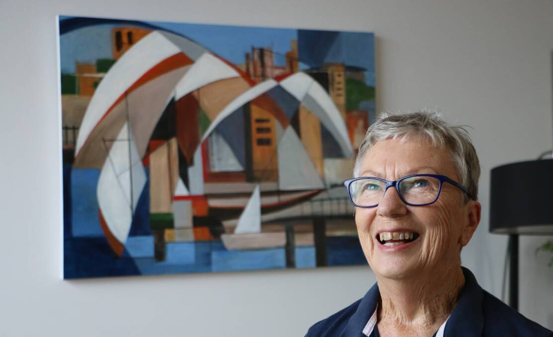 FREE LANDSCAPE: Stephanie Macfarlane with one of her paintings which hangs in her home at Wangi Wangi. Picture: David Stewart